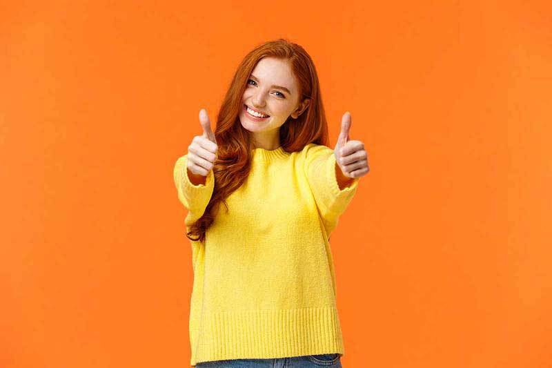 Girl with her thumbs up