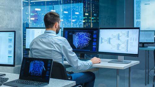 a network system administrator studies a detailed network mapping screen