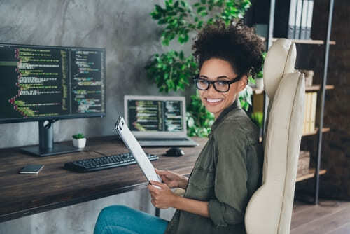 computer information research scientist smiles at her desk
