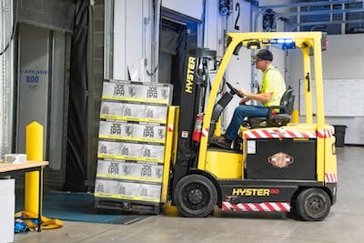 warehouse worker operating a forklift