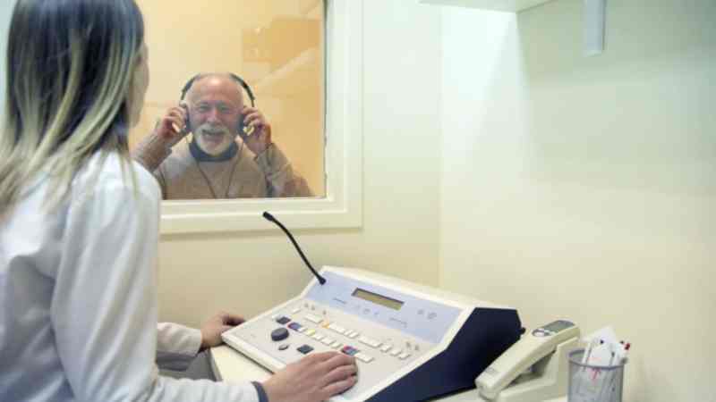hearing aid specialist conducting a hearing test