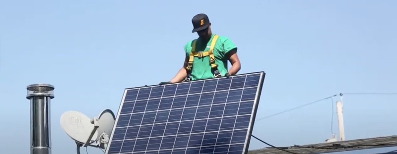 Renewable Energy Technician installing a solar pannel