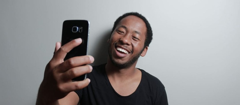 Digital content creator taking a selfie while smiling